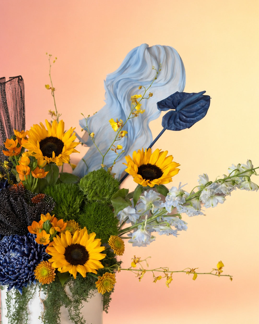 Blue Eclipse flower box with sunflowers, blue delphinium and mixed blooms in an elegant box from Whimsy Flowers Abu Dhabi.