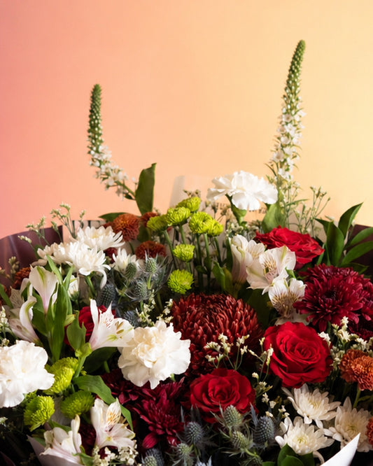 Burgundy Bliss flower bouquet with deep burgundy and cream blooms in luxe wrap from Whimsy Flowers Abu Dhabi.