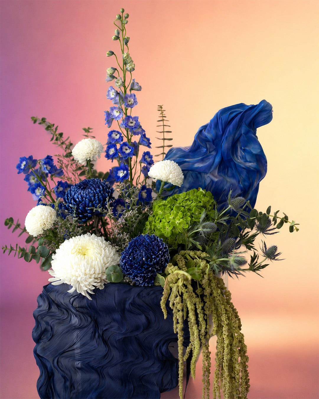 Celestial Blue flower bag arrangement with deep blue and dried florals in a stylish carry bag from Whimsy Flowers Abu Dhabi.