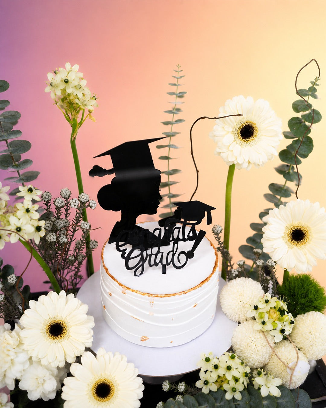 Graduation Grace cake box with flowers and celebration cake from Whimsy Flowers Abu Dhabi.