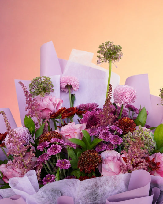 Lilac Dream flower bouquet with lilac and pink florals in soft purple wrap from Whimsy Flowers Abu Dhabi.