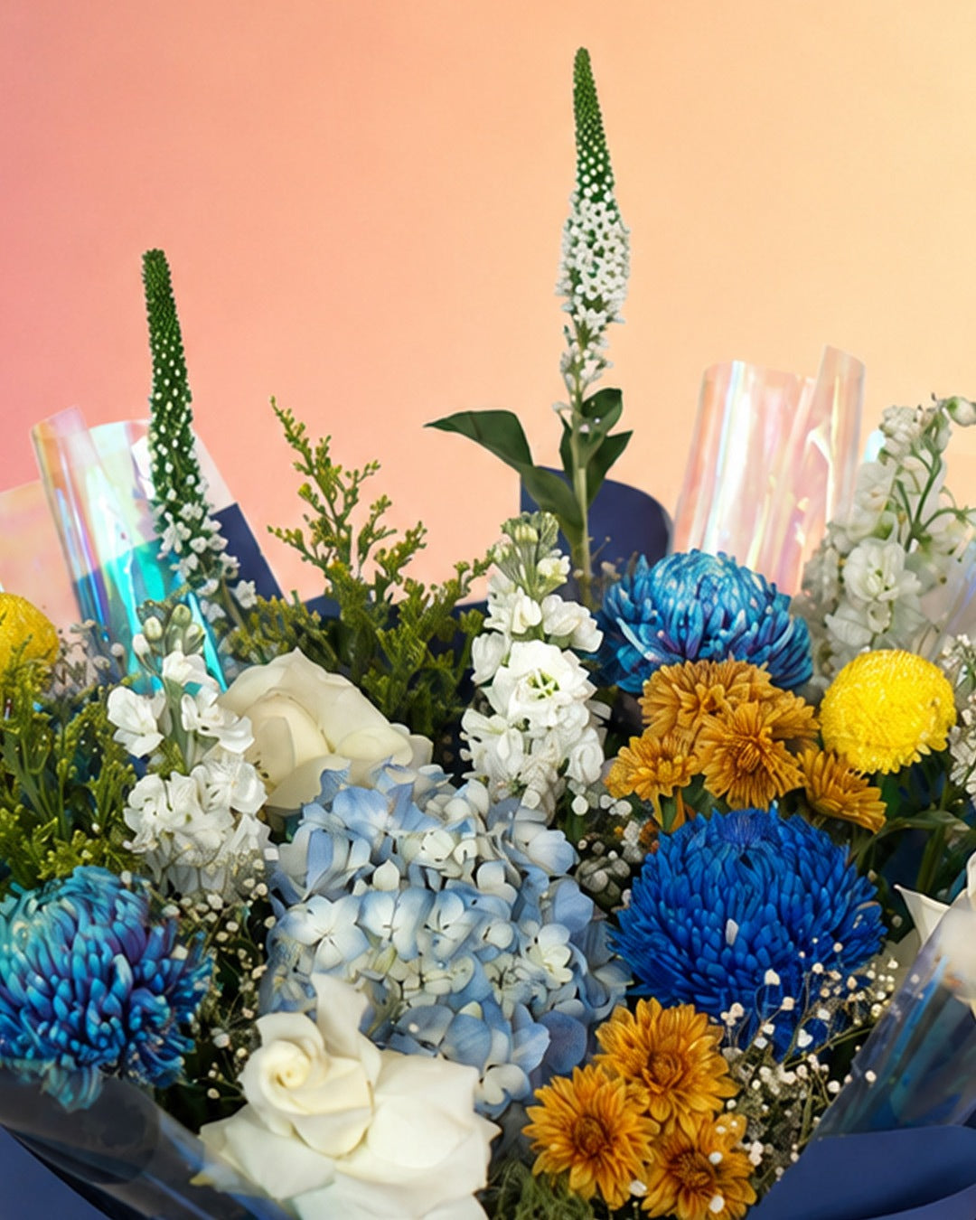 Ocean Whisper flower bouquet with blue, yellow and white mixed blooms in navy wrap from Whimsy Flowers Abu Dhabi.