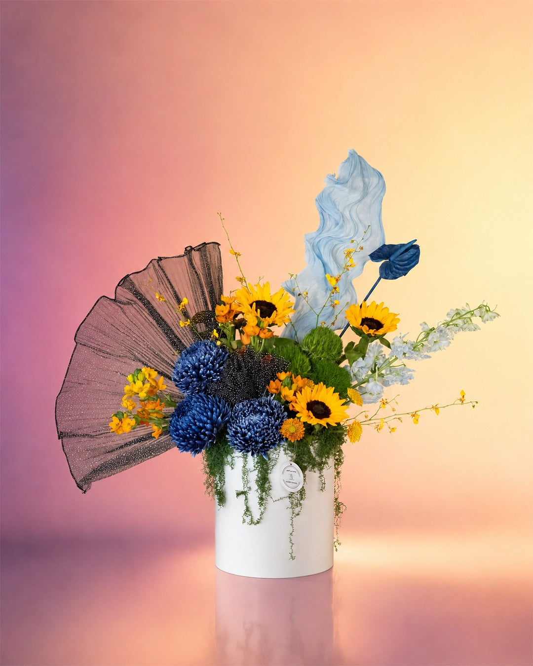 Blue Eclipse flower box with sunflowers, blue delphinium and mixed blooms in an elegant box from Whimsy Flowers Abu Dhabi.