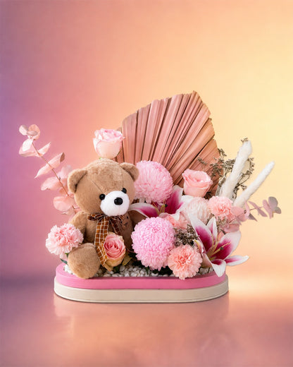 Blush Cuddles new born baby gift with pink flowers and teddy bear from Whimsy Flowers Abu Dhabi.
