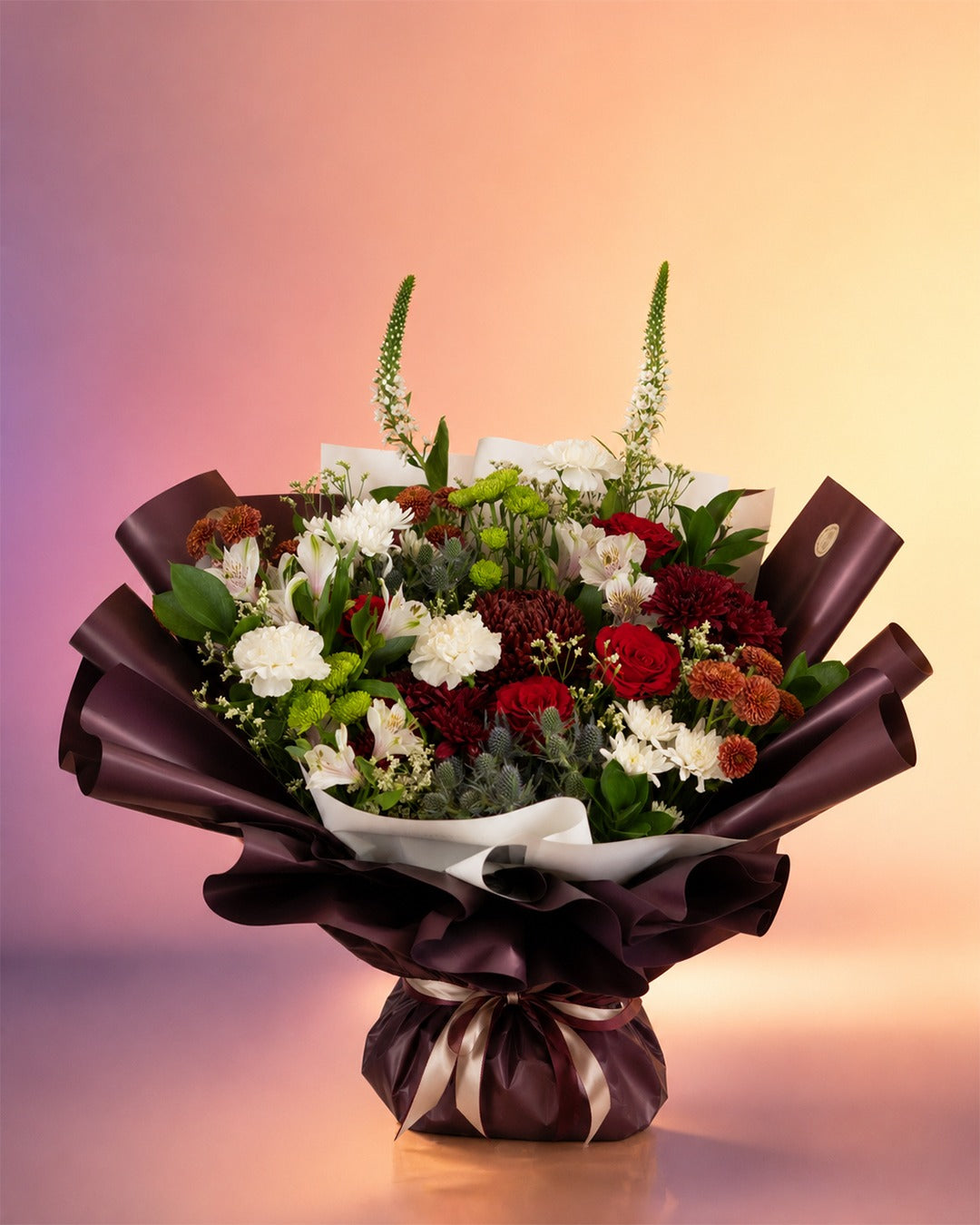 Burgundy Bliss flower bouquet with deep burgundy and cream blooms in luxe wrap from Whimsy Flowers Abu Dhabi.