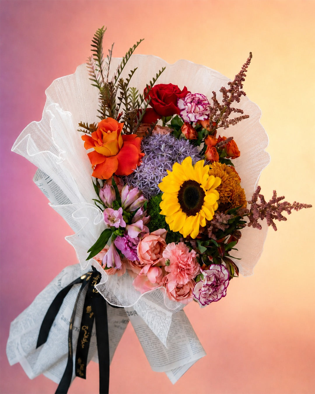 Floral Rhapsody flower bouquet with sunflowers and vibrant mixed blooms from Whimsy Flowers Abu Dhabi.
