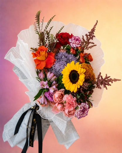 Floral Rhapsody flower bouquet with sunflowers and vibrant mixed blooms from Whimsy Flowers Abu Dhabi.