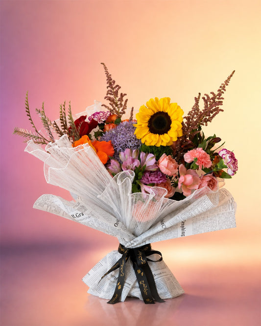 Floral Rhapsody flower bouquet with sunflowers and vibrant mixed blooms from Whimsy Flowers Abu Dhabi.
