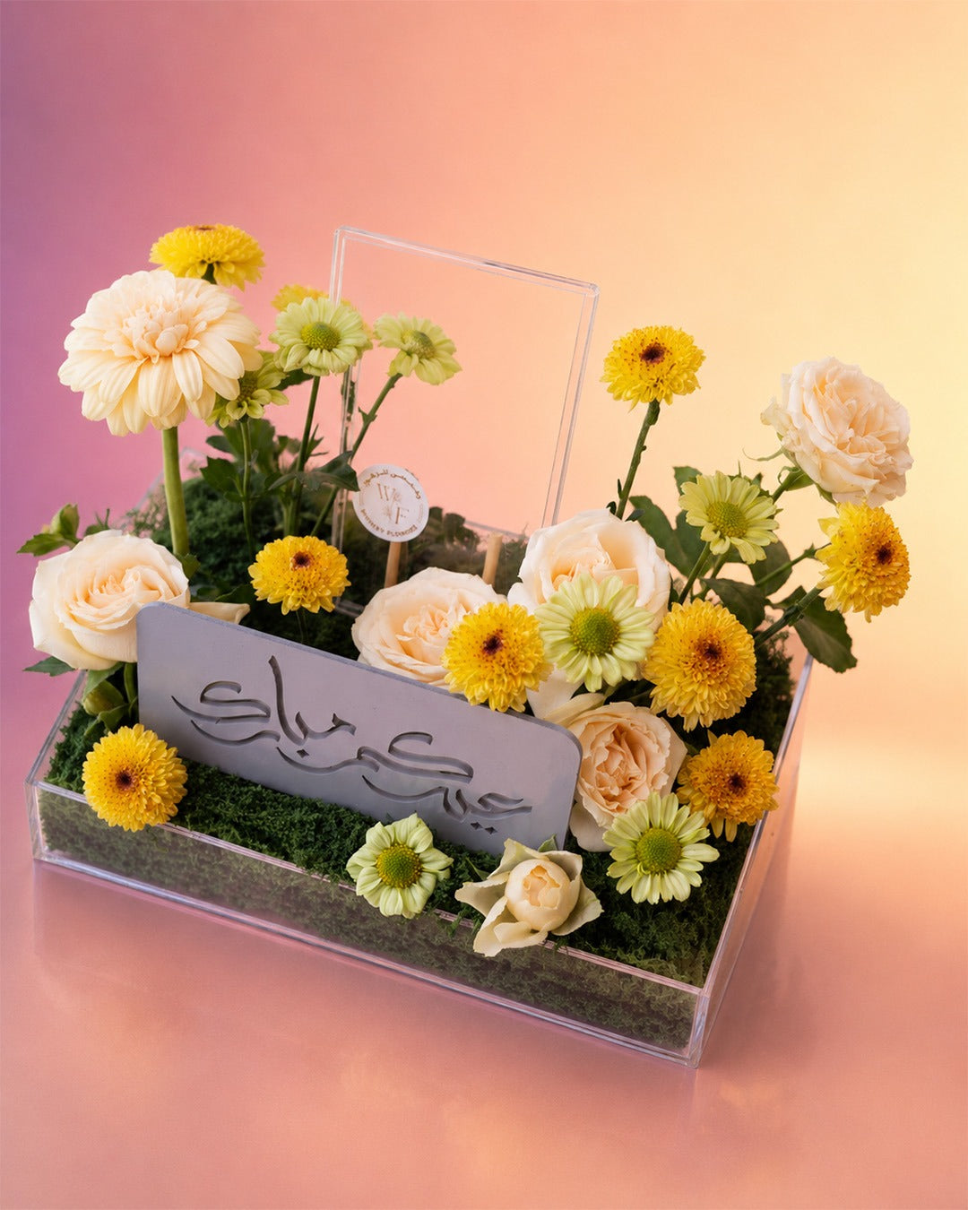 Golden Delight flower tray arrangement with yellow gerberas and a candle centerpiece from Whimsy Flowers Abu Dhabi.