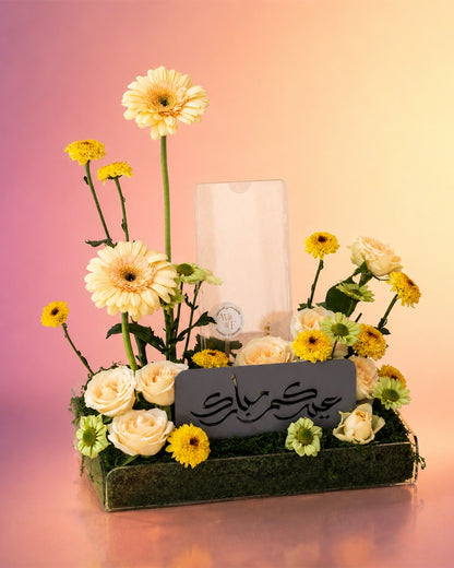 Golden Delight flower tray arrangement with yellow gerberas and a candle centerpiece from Whimsy Flowers Abu Dhabi.