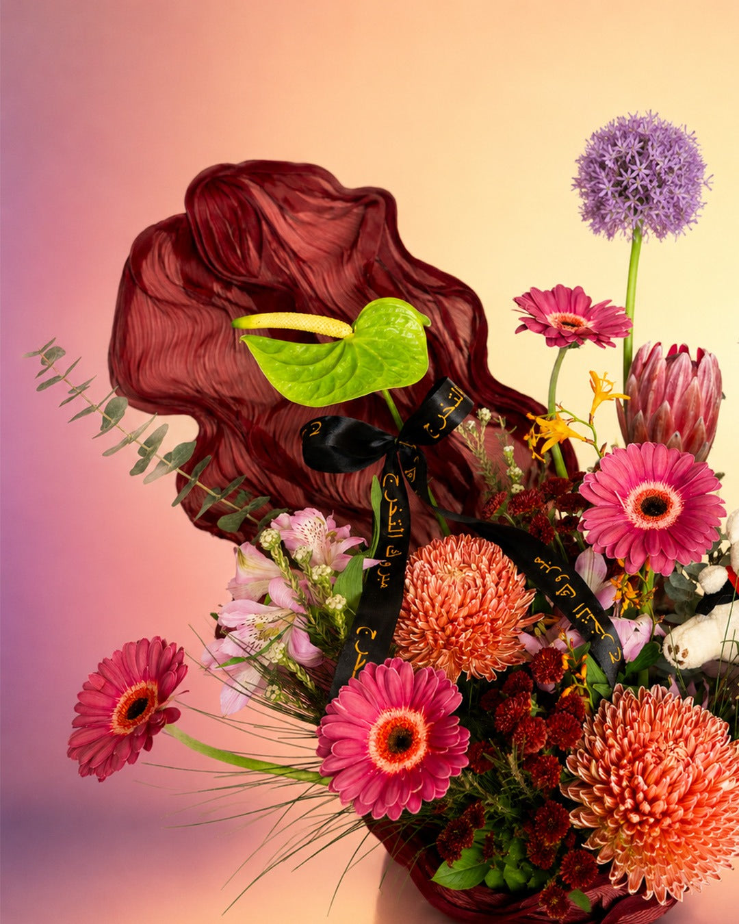 Graduation Garden Luxe flower arrangement with luxe mixed blooms in a black vase from Whimsy Flowers Abu Dhabi. 