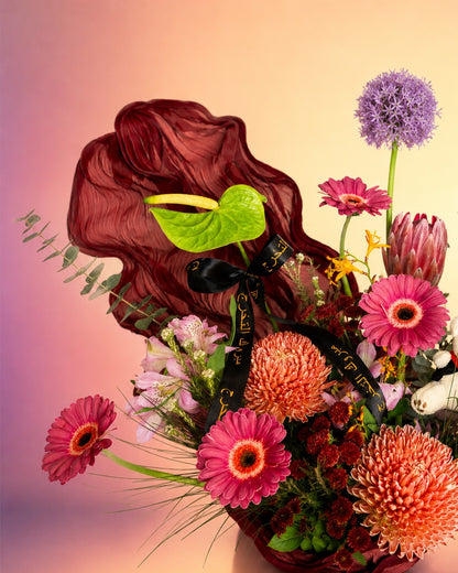 Graduation Garden Luxe flower arrangement with luxe mixed blooms in a black vase from Whimsy Flowers Abu Dhabi. 