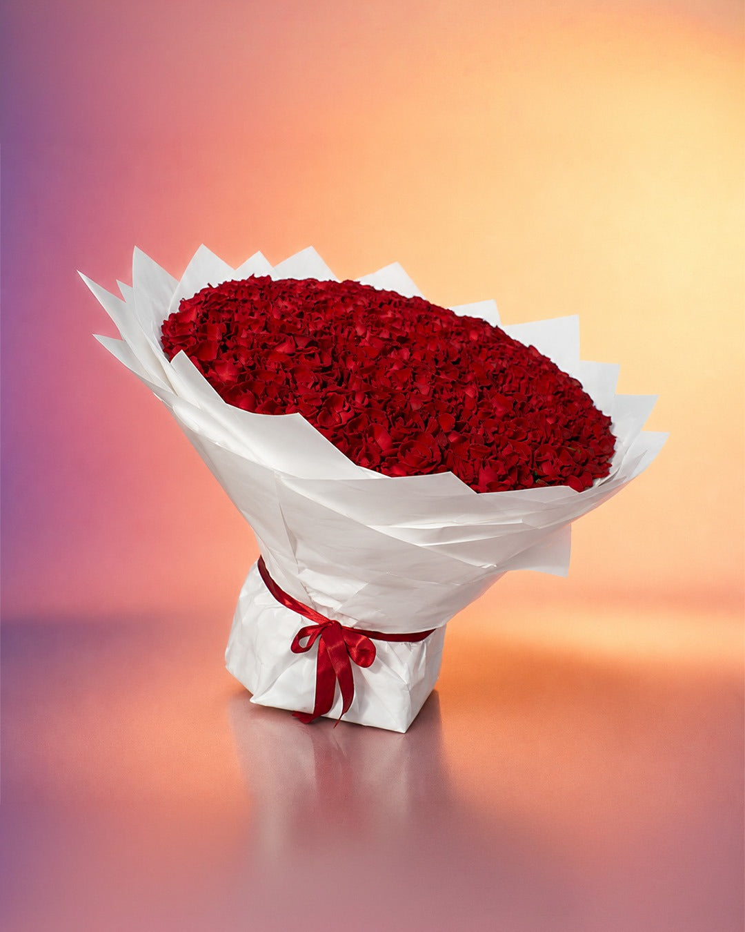 Heart of Roses bouquet with rich red roses in an elegant white wrap from Whimsy Flowers Abu Dhabi.