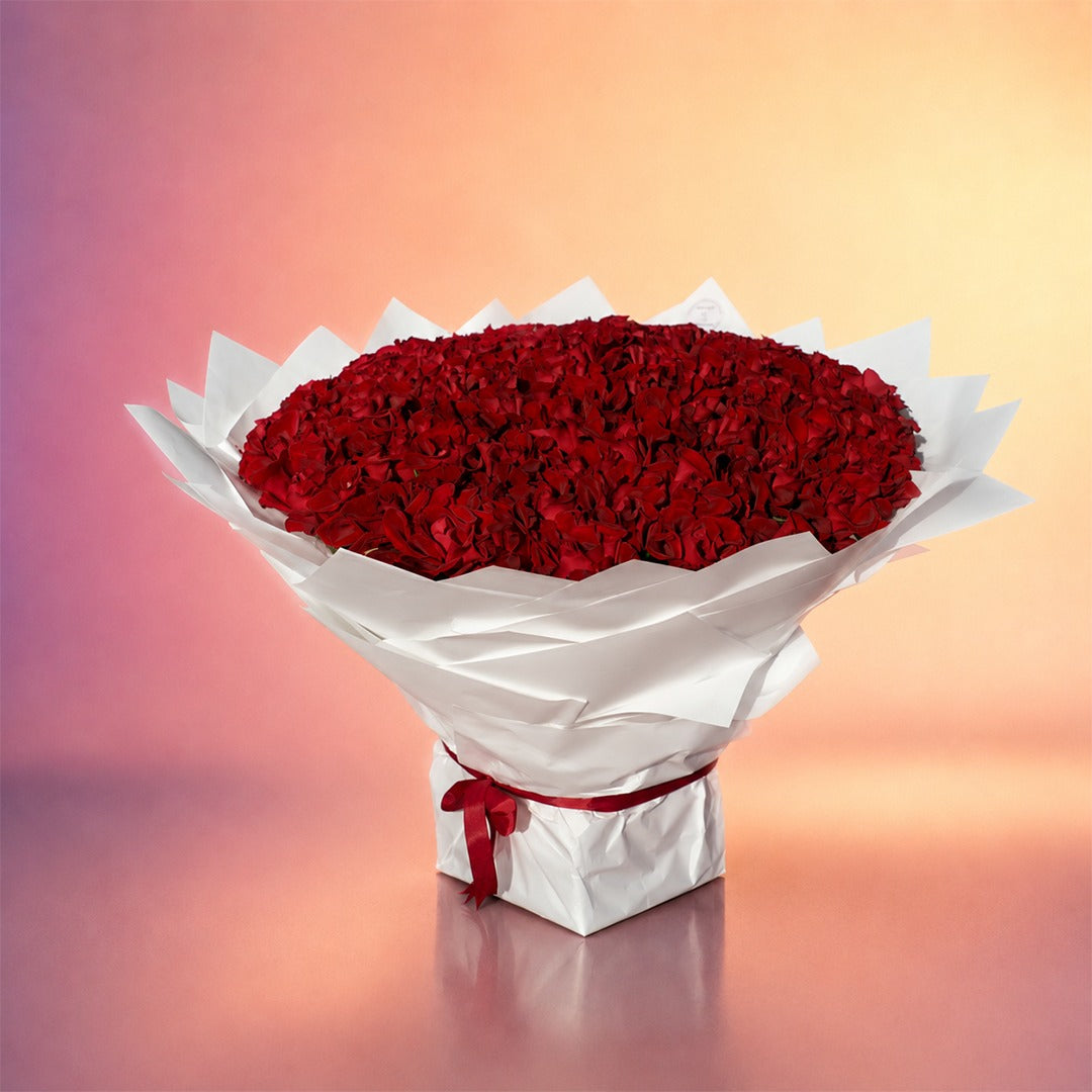 Heart of Roses bouquet with rich red roses in an elegant white wrap from Whimsy Flowers Abu Dhabi.