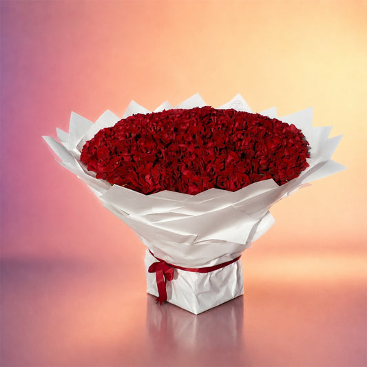Heart of Roses bouquet with rich red roses in an elegant white wrap from Whimsy Flowers Abu Dhabi.