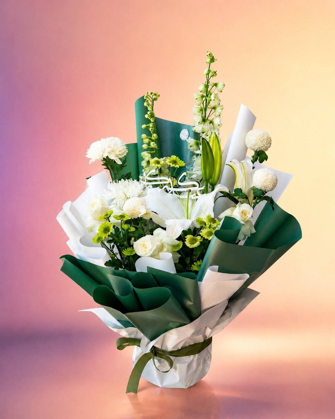 Ivory Elegance flower bouquet with white lilies, roses and lush greenery from Whimsy Flowers Abu Dhabi.
