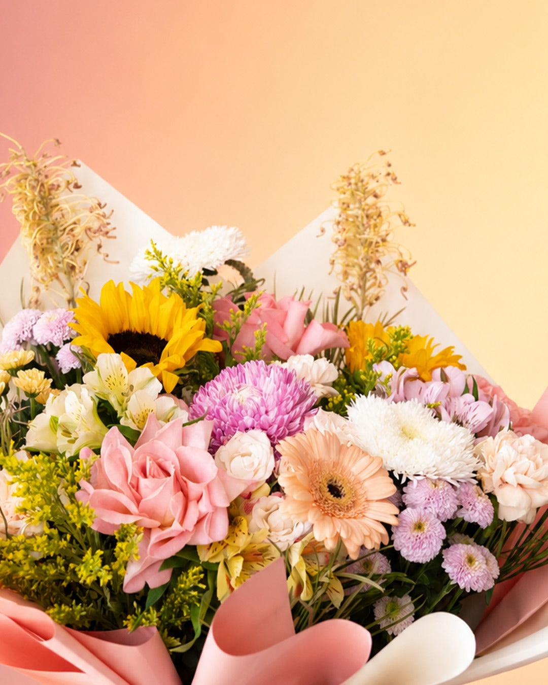 Joyful Garden flower bag arrangement with mixed pastel garden blooms in a stylish carry bag from Whimsy Flowers Abu Dhabi.