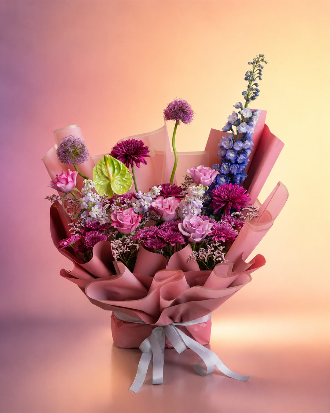 Lavender Kiss flower bouquet with lavender and pink blooms in soft wrap from Whimsy Flowers Abu Dhabi.