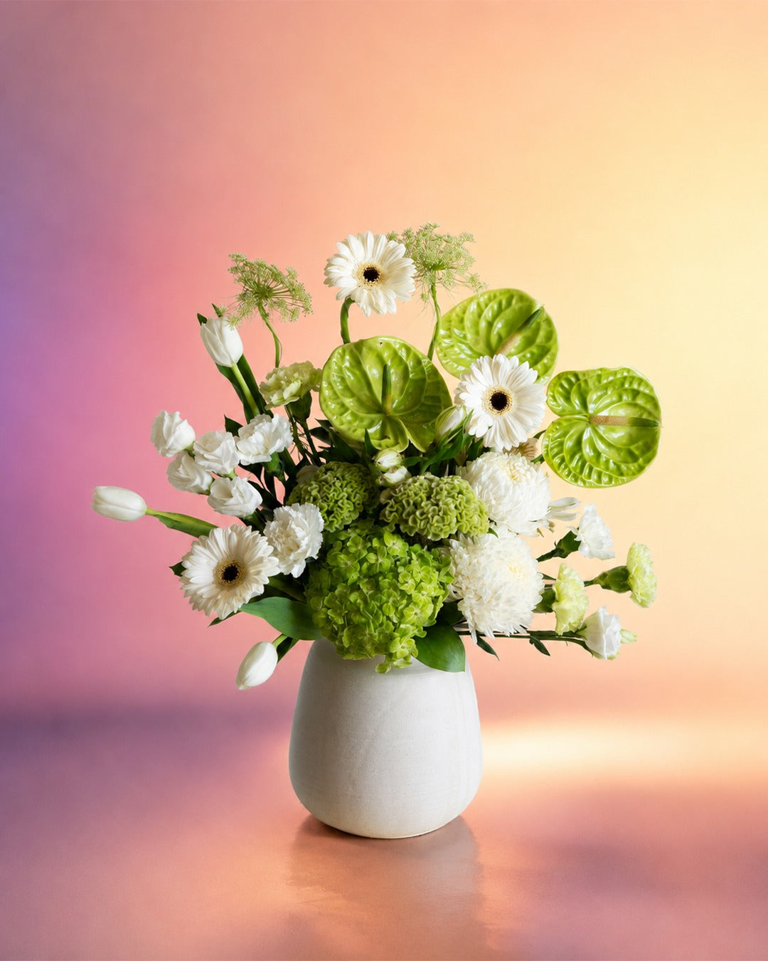 Lime Whisper flower vase arrangement with fresh green and white blooms in a white vase from Whimsy Flowers Abu Dhabi.