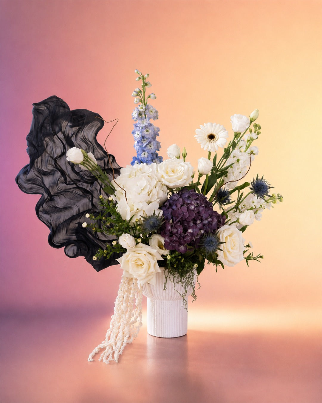 Midnight Elegance new born baby flower arrangement with dark purple and white blooms from Whimsy Flowers Abu Dhabi.