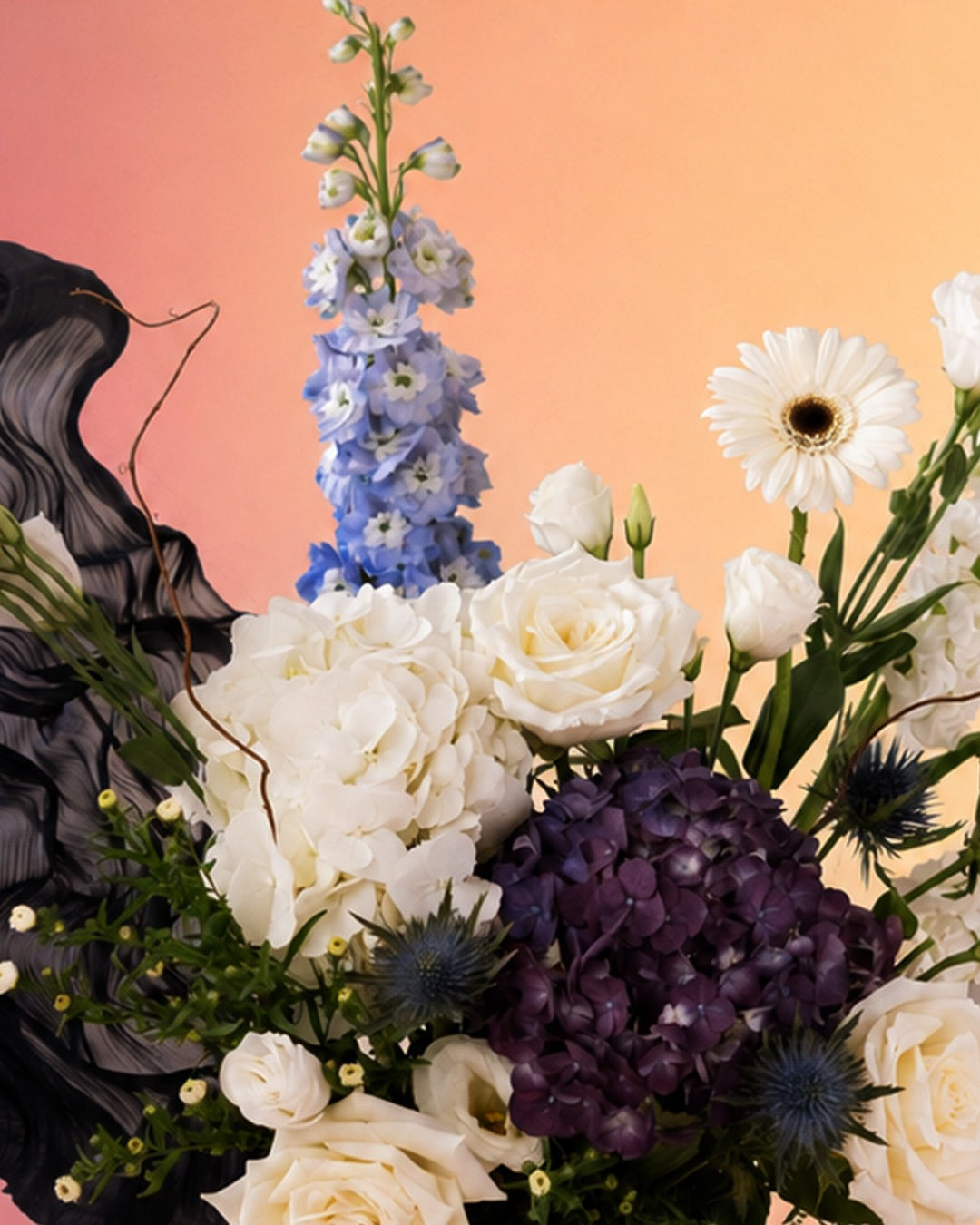 Midnight Elegance new born baby flower arrangement with dark purple and white blooms from Whimsy Flowers Abu Dhabi.