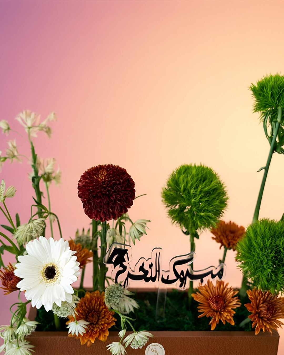 Noor Al Hajj flower tray arrangement with red and green florals for Hajj celebrations from Whimsy Flowers Abu Dhabi.