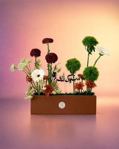 Noor Al Hajj flower tray arrangement with red and green florals for Hajj celebrations from Whimsy Flowers Abu Dhabi.