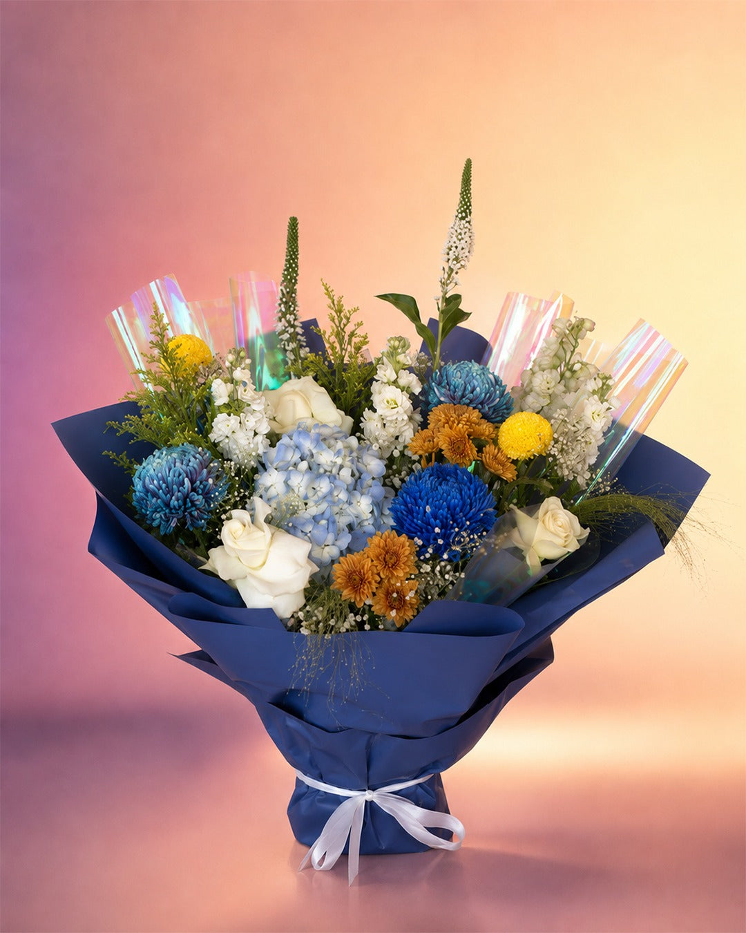 Ocean Whisper flower bouquet with blue, yellow and white mixed blooms in navy wrap from Whimsy Flowers Abu Dhabi.