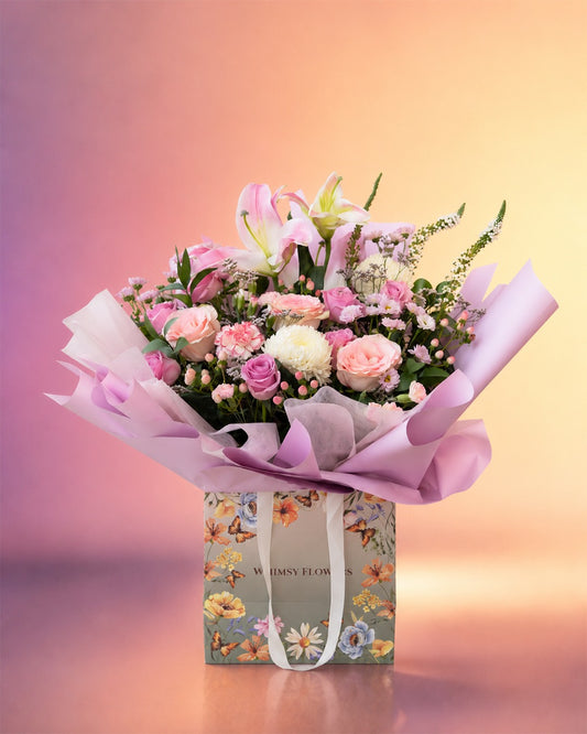 Pink Lily Elegance flower bouquet with pink lilies and roses in a stylish wrap from Whimsy Flowers Abu Dhabi.