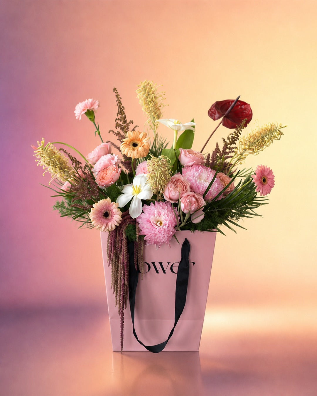 Pink Rhapsody flower bouquet with soft pink dried florals in a stylish carry bag from Whimsy Flowers Abu Dhabi.