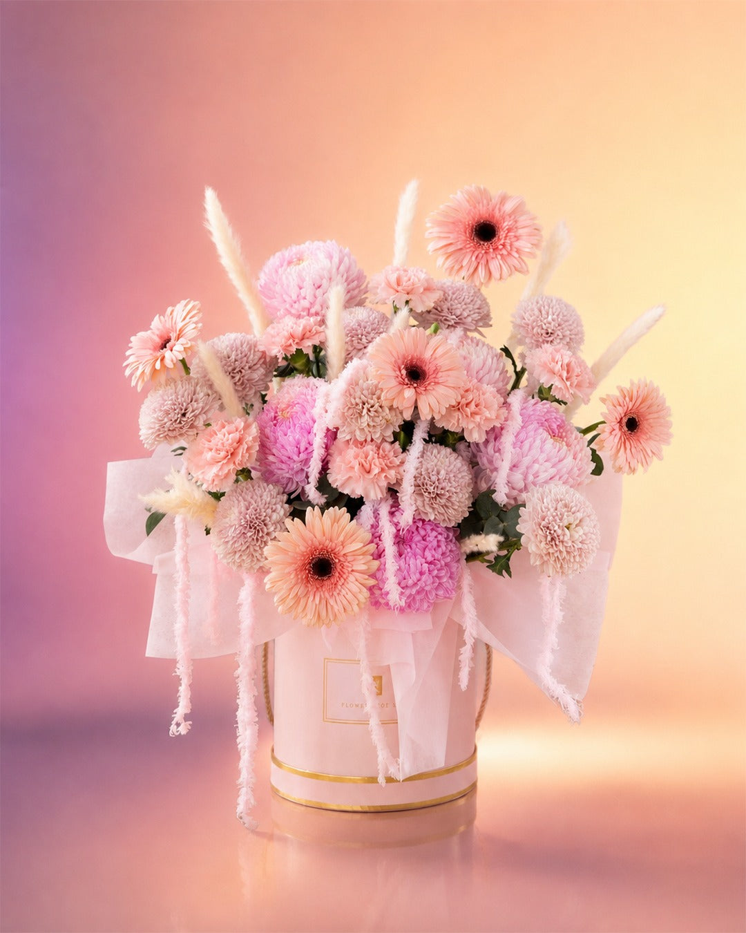 Pink Symphony flower box arrangement with soft pink gerberas, roses and dahlias in an elegant box from Whimsy Flowers Abu Dhabi.