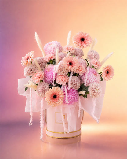 Pink Symphony flower box arrangement with soft pink gerberas, roses and dahlias in an elegant box from Whimsy Flowers Abu Dhabi.