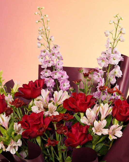 Red Velvet Serenade flower bouquet with rich red roses in an elegant wrap from Whimsy Flowers Abu Dhabi.