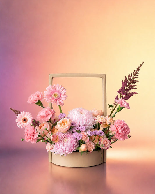 Rose Whisper new born baby flower arrangement with soft pink and mauve blooms from Whimsy Flowers Abu Dhabi.