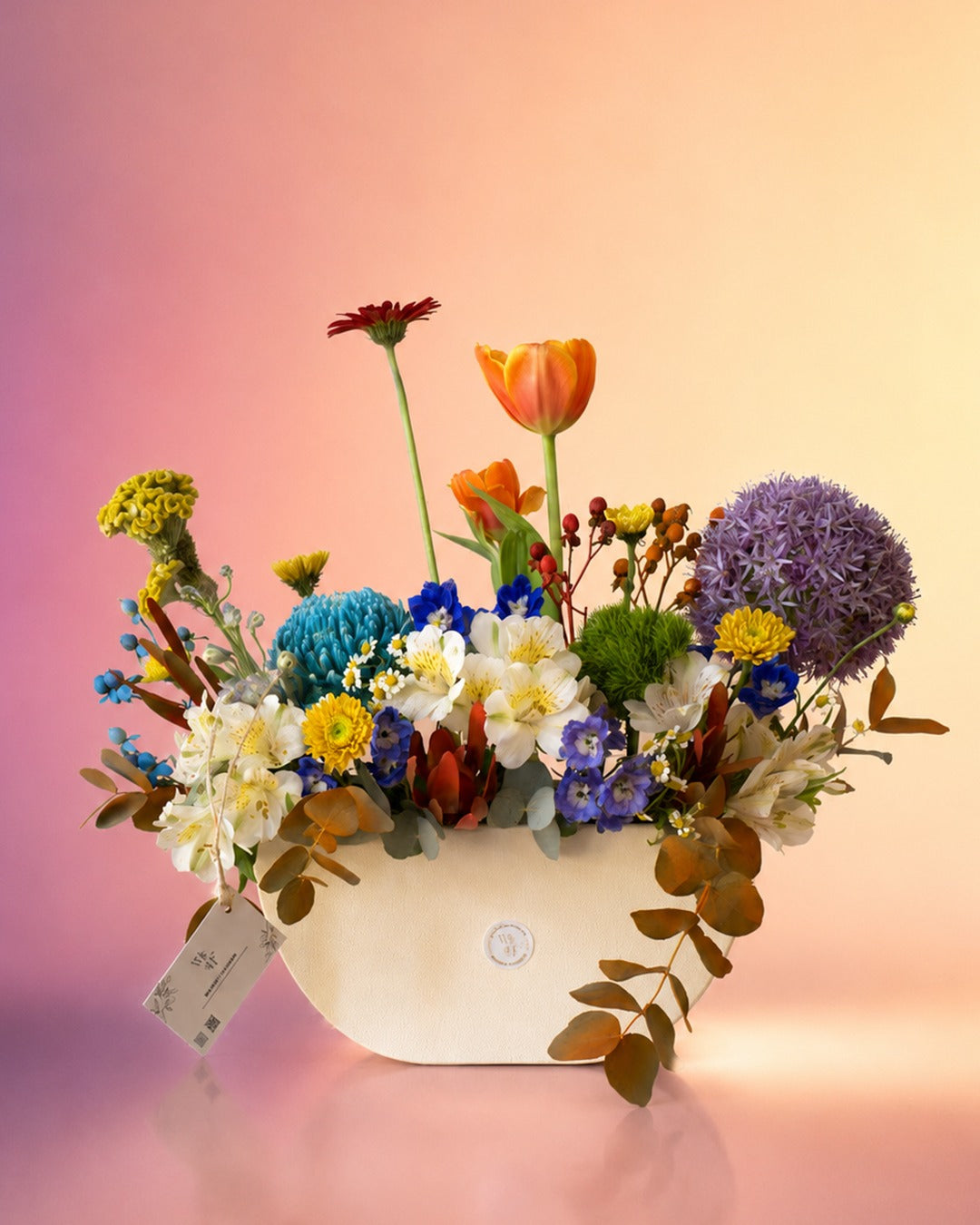 Spring Kaleidoscope flower vase arrangement with vibrant mixed spring blooms in a white vase from Whimsy Flowers Abu Dhabi.