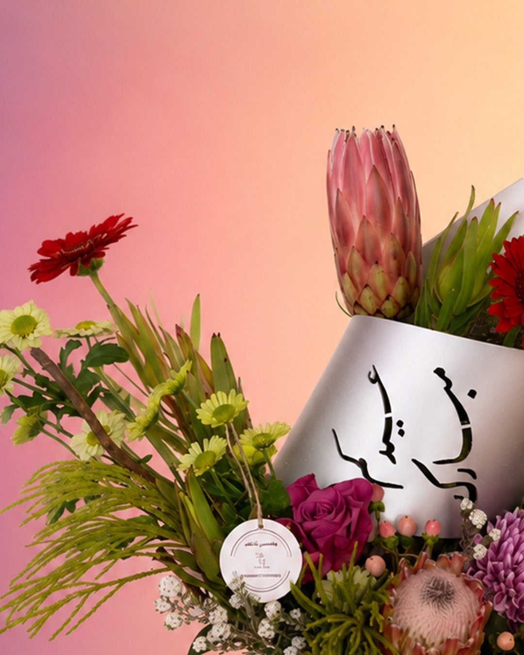 Zenith Bloom flower tray arrangement with red and burgundy blooms in a rustic tray from Whimsy Flowers Abu Dhabi.