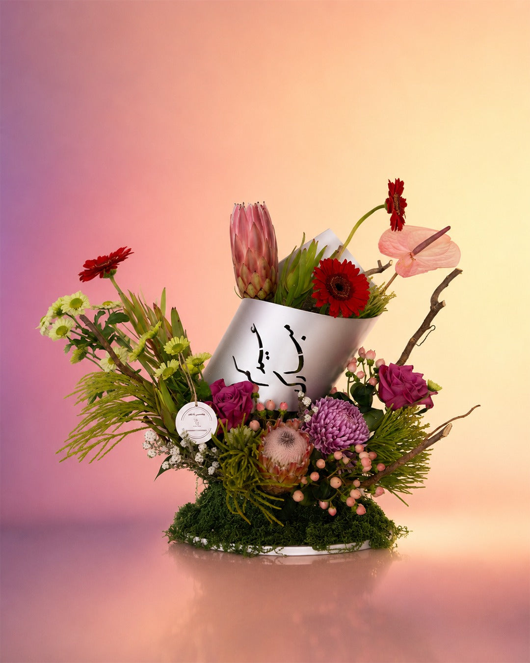 Zenith Bloom flower tray arrangement with red and burgundy blooms in a rustic tray from Whimsy Flowers Abu Dhabi.
